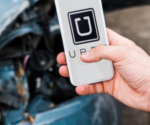 man holding phone after uber car accident in baltimore maryland