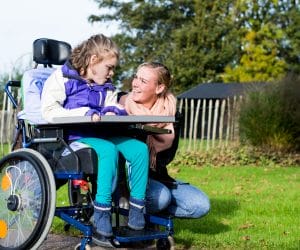 A child, disabled from a birth injury, and her mother at a park in Maryland.