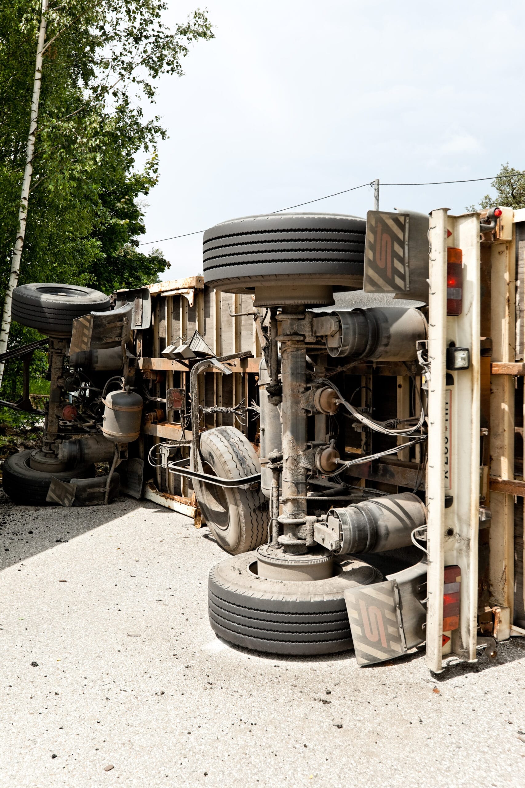 Overturned truck on the side of the road.