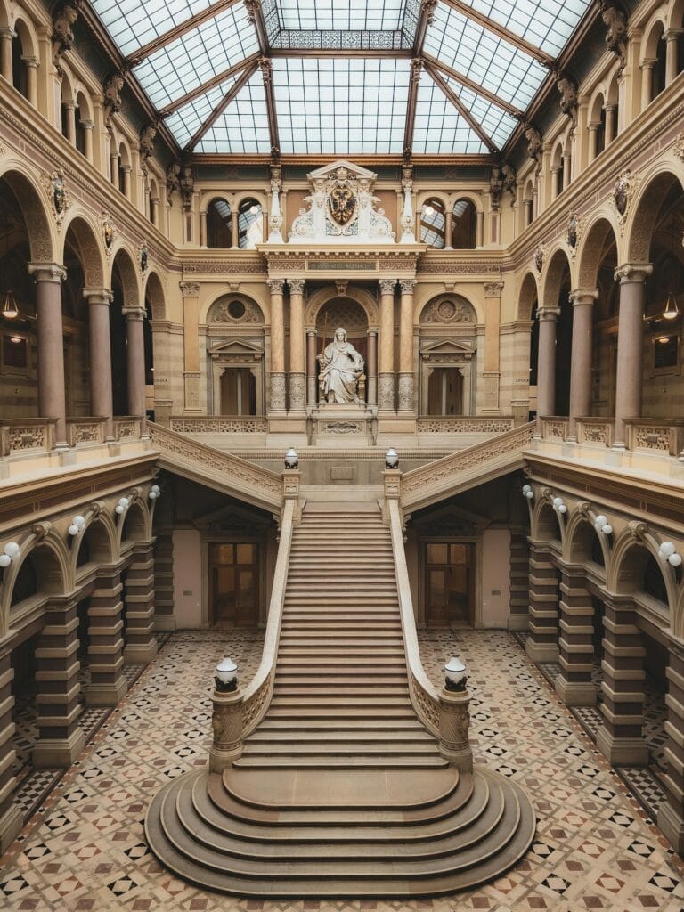 Majestic staircase inside a historic palace in Vienna, showcasing classic architecture.