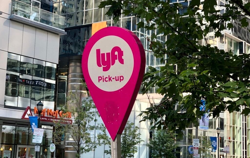 Lyft pick-up location sign in city.