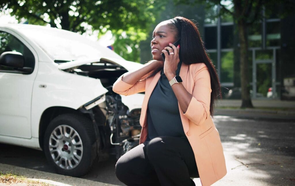 Woman on phone after car accident scene